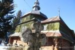 A wooden church and a stone cross in Urman, Western Ukraine
