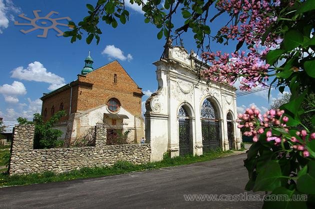 Брама зруйнованого палацу Баворовських і костел, перетворений на житло. Село Острів, 5 травня 2017 р.